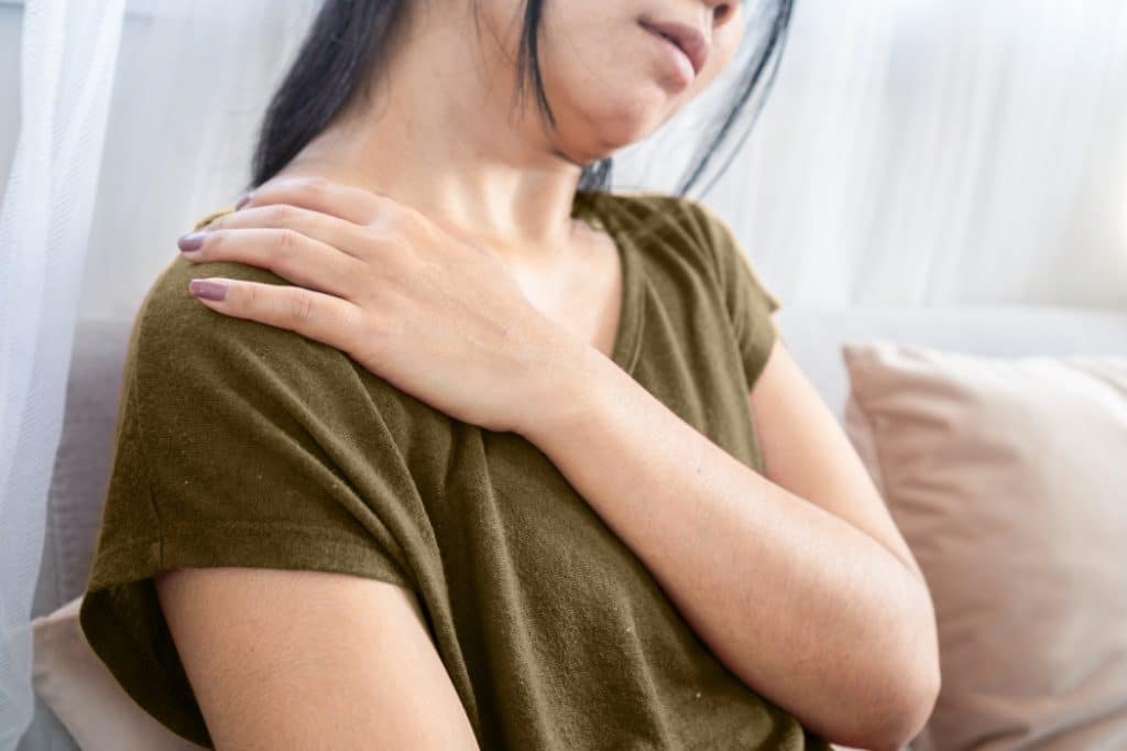 A woman suffers from persistent neck and shoulder pain