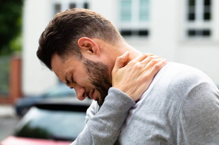 A man suffers from neck and shoulder pain